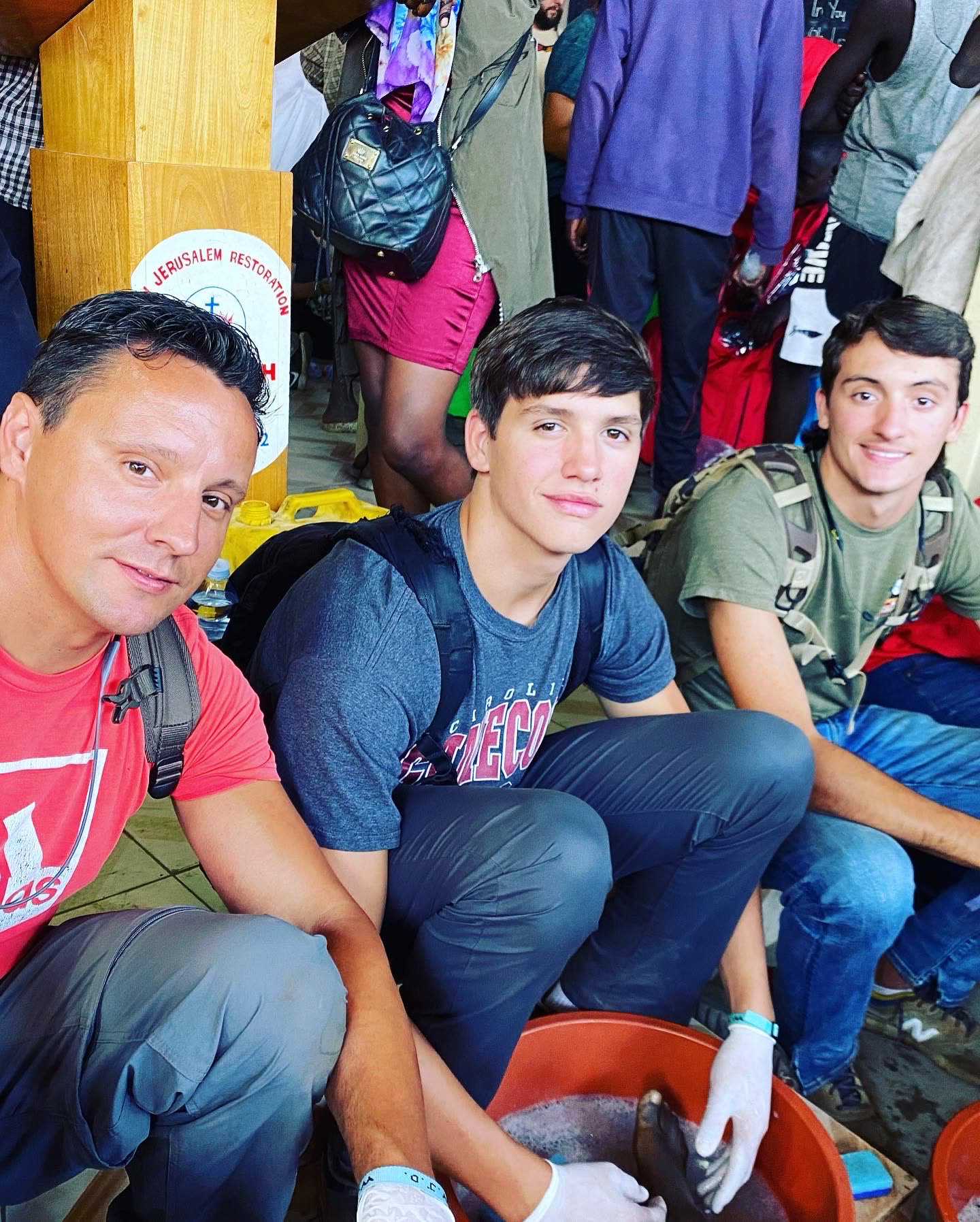 A father and sons serving together during a Uganda mission
